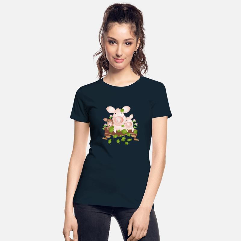 three lucky pigs with four-leaf clovers